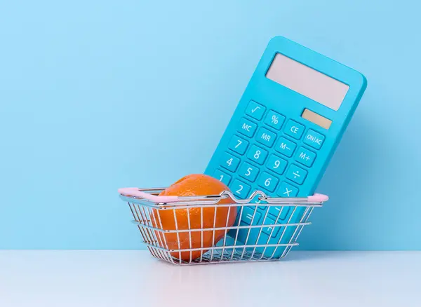 stock image Miniature shopping cart and calculator