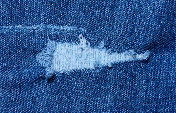 Fragment Van Blauwe Jeans Stof Met Een Gat Volledige Frame — Stockfoto