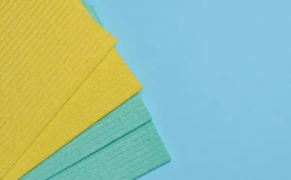 Square sponges for the kitchen and home on a blue background