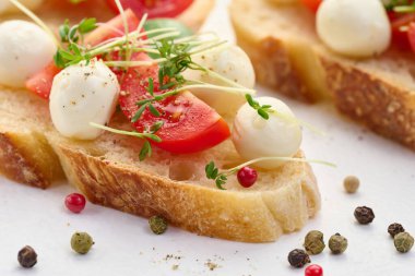 Yuvarlak mozzarella, kiraz domatesleri ve bir parça beyaz ekmek, sağlıklı bir sandviç, yakın çekim.