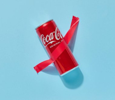 Ukrayna, Mykolaiv - 10 Mayıs 2025: Kırmızı yapışkan bantla sarılmış kırmızı bir Coca-Cola marka soda kutusu