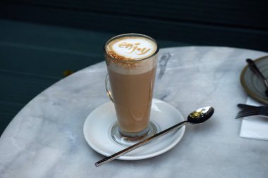 Close-up of latte coffee in a transparent cup with 