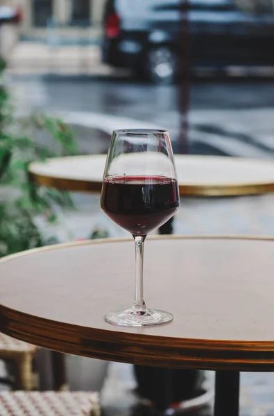 stock image A glass of red wine on the summer terrace of a Parisian restaurant