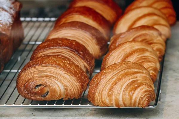 stock image Close-up of fresh and beautiful french pastries (croissants, pains au chocolat) in a bakery showcase