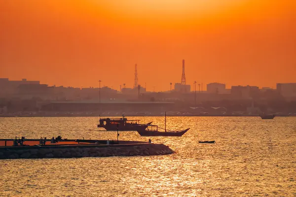 Renkli bir günbatımında Doha rıhtımında