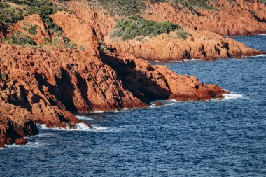 Red cliffs on the coast near Cap Dramont and Saint-Raphael on the French Riviera clipart