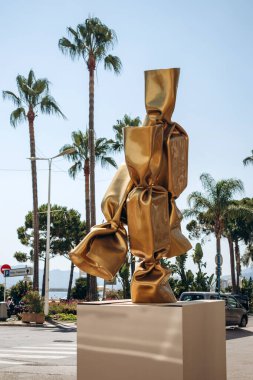 Cannes, France - August 1, 2024: Sculpture by Laurence JENK in the form of a candy, in the center of Cannes on the Croisette embankment clipart