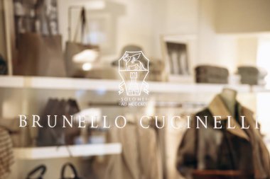 Bologna, Italy - October 6, 2024: Window display of the Brunello Cucinelli boutique in the Galleria Cavour clipart