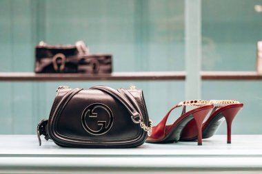 Cannes, France - 10 November 2024: Gucci bag and sandals displayed in a boutique window on the Croisette promenade in Cannes clipart