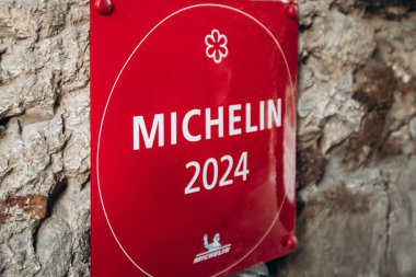 Ljubljana, Slovenia - 14 August 2024: Michelin one-star sign displayed outside a prestigious restaurant clipart