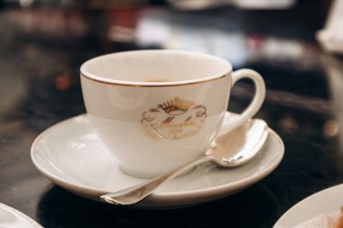 Milan, Italy - August 20, 2024:  Coffee cup at the historical Pasticceria Marchesi 1824 at Galleria Vittorio Emanuele II, Milano clipart