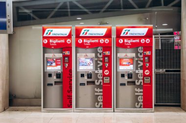 Milan, Italy - August 20, 2024: Trenitalia ticket machines at Milano Centrale station clipart