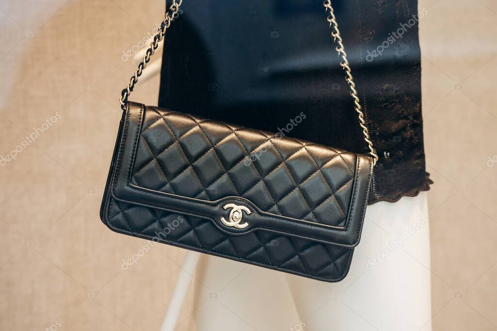 Milan, Italy - August 20, 2024: A Chanel bag in a boutique window on the famous shopping street Montenapoleone in Milan