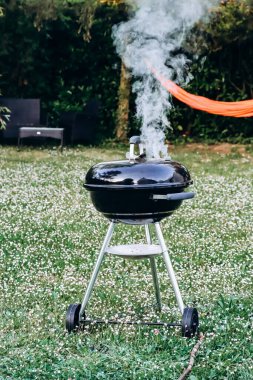 Closed charcoal barbecue grill in the garden