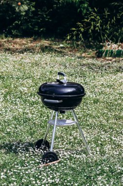 Closed charcoal barbecue grill in the garden