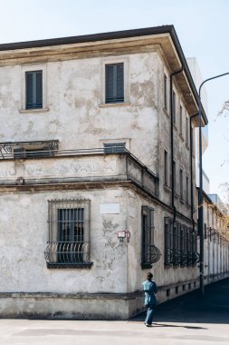 Milan, İtalya - 19 Mart 2025: Fondazione Prada Milano 'daki yıpranmış sıva ve giriş kapısı ile tarihi cadde cephesi