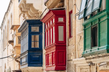 Geleneksel Malta ahşap balkonları kireçtaşı cephelerine canlı renklerle boyanmış, tipik tarihi şehir merkezi mimarisi..