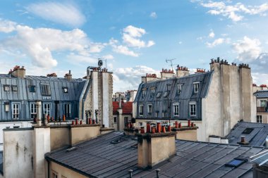 Classic Paris rooftops with chimneys and mansard windows