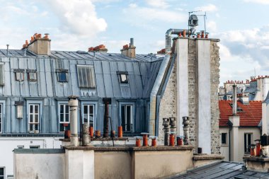 Classic Paris rooftops with chimneys and mansard windows