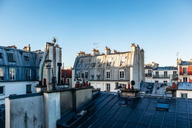 Classic Paris rooftops with chimneys and mansard windows