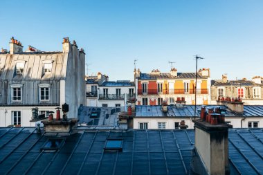 Classic Paris rooftops with chimneys and mansard windows
