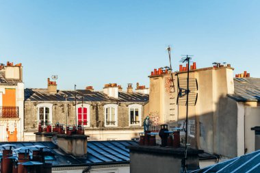 Classic Paris rooftops with chimneys and mansard windows