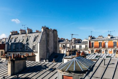 Classic Paris rooftops with chimneys and mansard windows