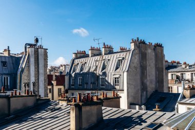 Classic Paris rooftops with chimneys and mansard windows