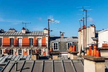 Classic Paris rooftops with chimneys and mansard windows