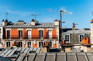 Classic Paris rooftops with chimneys and mansard windows