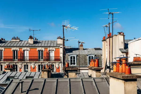 Classic Paris rooftops with chimneys and mansard windows