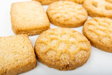 Danish cookies on a white ceramic tray on a towel on a white background, breakfast, pastries, delicious shortbread cookies, white background, catalog photo of food