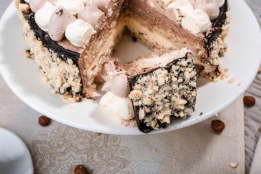 Fındıklı Kyiv keki, beyaz bir tabakta beyaz bir kek tepsisinde krema, espresso kahvesi, altın çatal bıçak takımı, Ukrayna tatlıları, fındıklı kek, flatlay