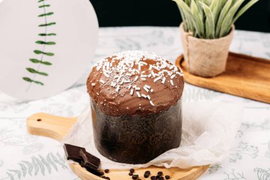 Paskalya pastası, arka planda çikolata jöleli Paskalya ekmeği, çiçekler, çikolata, çikolata damlaları. Paskalya konsepti