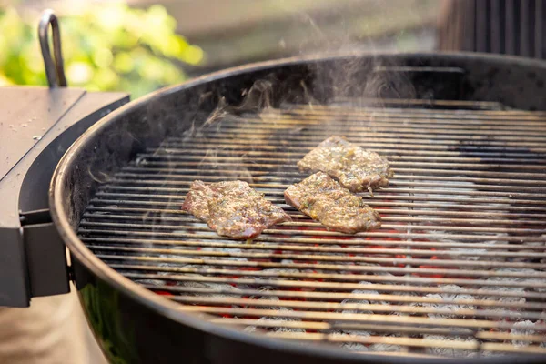 stock image Cooking meat on a round grill outdoor picnic