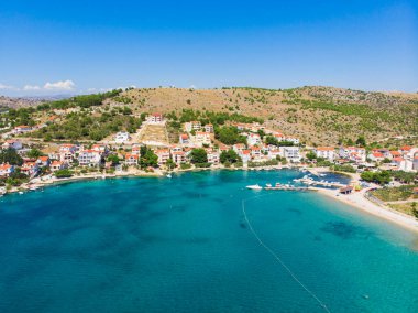 Hırvatistan. Yaz. Güneşli bir gün. Adriyatik Denizi kıyısında. Deniz kenarında küçük bir kasaba. Tatil sezonu. Popüler turizm merkezi