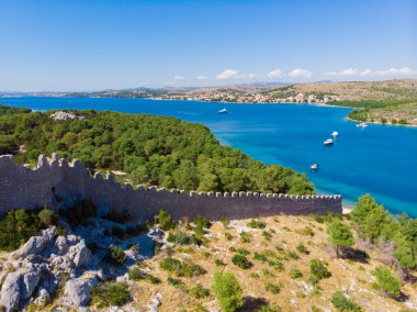 Hırvatistan. Yaz. Güneşli bir gün. Adriyatik Denizi kıyısında. Eski bir kalenin kalıntıları. Tatil sezonu. Popüler turist mekanı. Drone. Hava görünümü