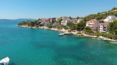 Croatia. Coast of the Adriatic Sea. Small town by the sea. Summer. Tourist season. Popular place to relaxation. Drone. Aerial view. The camera moves forward