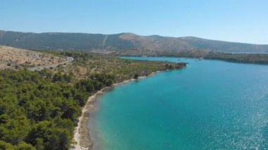 Croatia. Bay on the coast of the Adriatic Sea. Summer. Tourist season. Popular place to relaxation. Drone. Aerial view. The camera moves from left to right