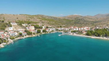 Croatia. Coast of the Adriatic Sea. Small town by the sea. Summer. Tourist season. Popular place to relaxation. Drone. Aerial view. The camera moves forward