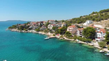 Croatia. Coast of the Adriatic Sea. Small town by the sea. Summer. Tourist season. Popular place to relaxation. Drone. Aerial view. The camera moves from left to right