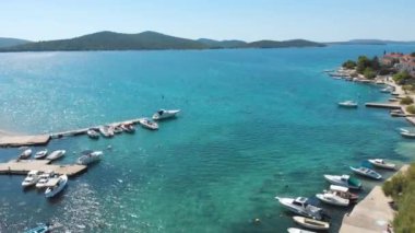 Croatia. Coast of the Adriatic Sea. Small town by the sea. Summer. Tourist season. Popular place to relaxation. Drone. Aerial view. The camera moves forward