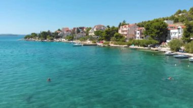 Croatia. Coast of the Adriatic Sea. Small town by the sea. Summer. Tourist season. Popular place to relaxation. Drone. Aerial view. The camera moves forward