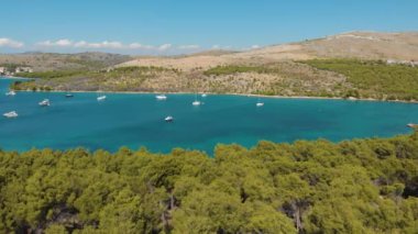 Croatia. Bay with yachts on the Adriatic coast. Summer. Tourist season. Popular place to relaxation. Drone. Aerial view. The camera moves from right to left