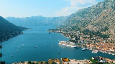 Montenegro. Drone. Flight over the Bay of Kotor. The camera moves from left to right. The largest bay on the Adriatic Sea. The southernmost fjord in Europe. Tourist liner in the parking lot
