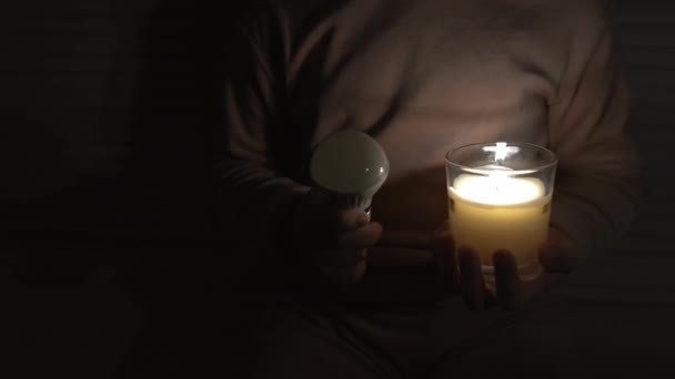 Girl Dark Room Holds Candle Led Light Bulb Her Hands — Vídeos de Stock