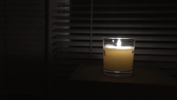 Candle Glass Cup Stands Dark Empty Room Window Close Camera — Vídeos de Stock