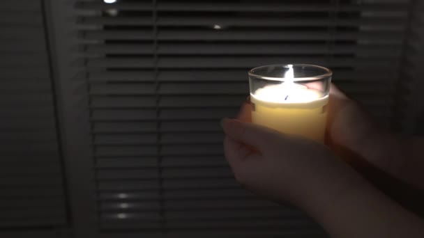 Girl Holds Candle Glass Both Hands Background Window Blinds Close — Video