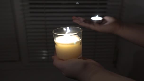 Two Burning Candles Hands Background Window Blinds Fixed Camera Close — Video