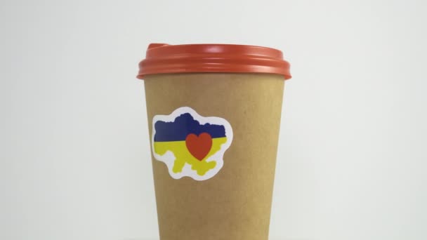 Rotating Paper Coffee Cup Love Ukraine Patriotic Sticker Gray Background — Wideo stockowe